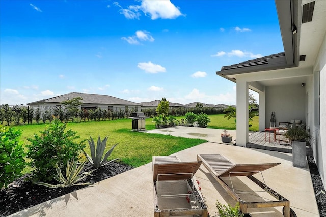 view of patio featuring fence and a grill