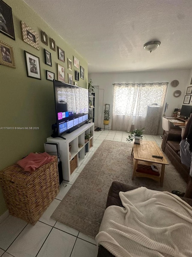 living area with light tile patterned floors and a textured ceiling