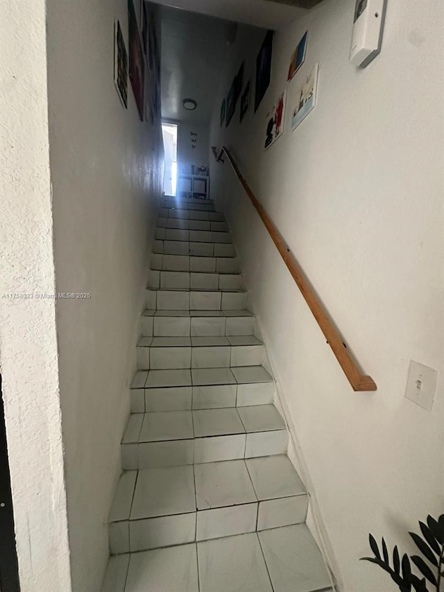 staircase with tile patterned flooring