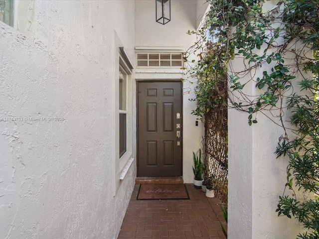 property entrance with stucco siding