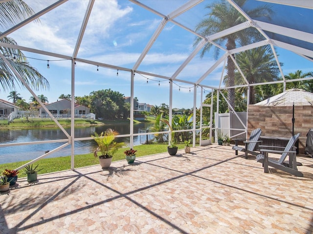 view of patio / terrace with a water view and a lanai