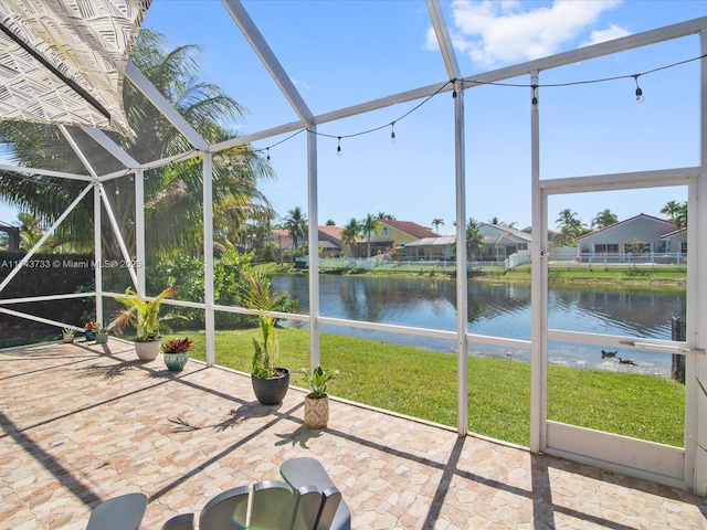 unfurnished sunroom featuring a water view