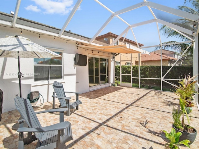 view of patio with glass enclosure