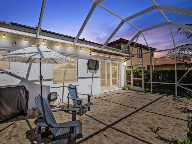 view of patio / terrace with a lanai and area for grilling