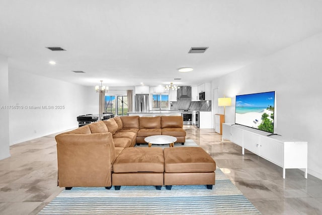 living area featuring an inviting chandelier and visible vents