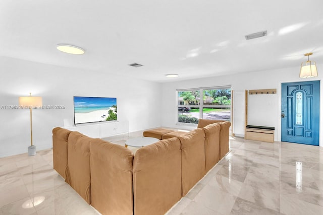 living room with marble finish floor, baseboards, and visible vents