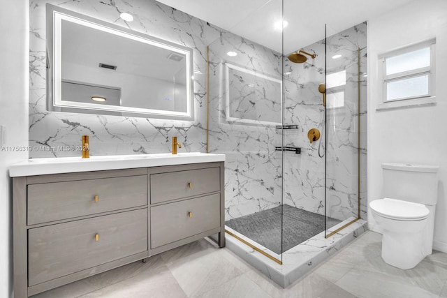 bathroom featuring marble finish floor, toilet, vanity, and a marble finish shower