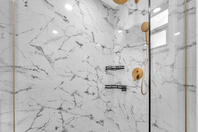 room details featuring a marble finish shower