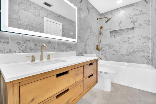 bathroom with tile walls, bathing tub / shower combination, visible vents, toilet, and vanity