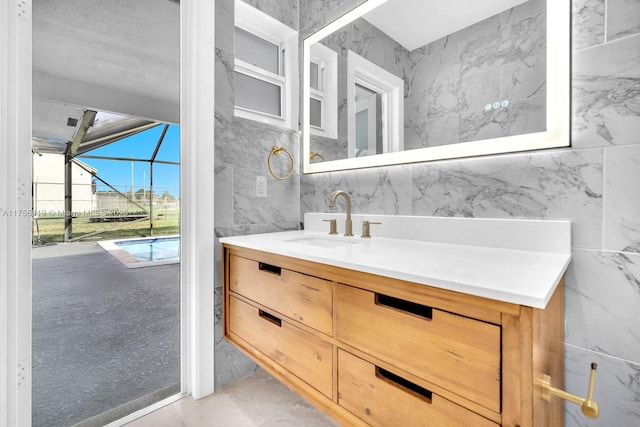 bathroom featuring tile walls and vanity