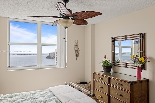 bedroom with a textured ceiling and ceiling fan