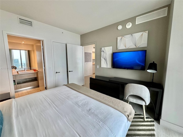 bedroom with ensuite bath and visible vents