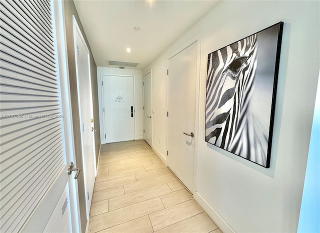 corridor with visible vents and wood finish floors