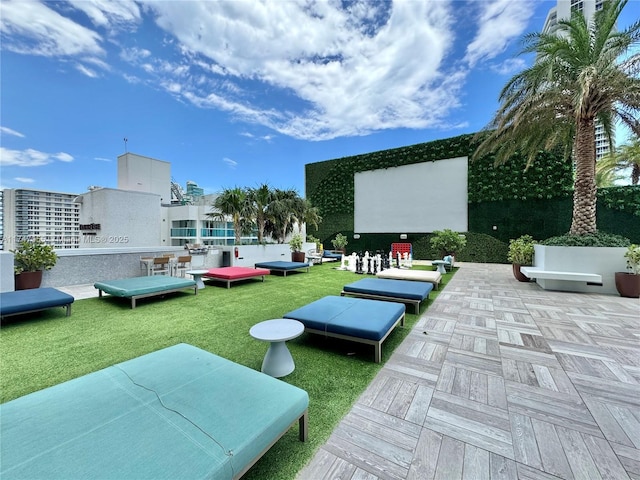 view of property's community with a patio area, outdoor lounge area, and a yard