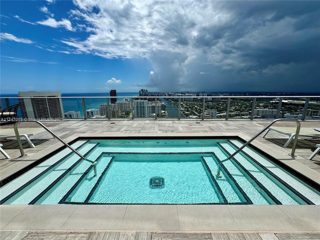 view of pool featuring a water view and a pool