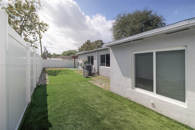 view of yard featuring cooling unit and a fenced backyard