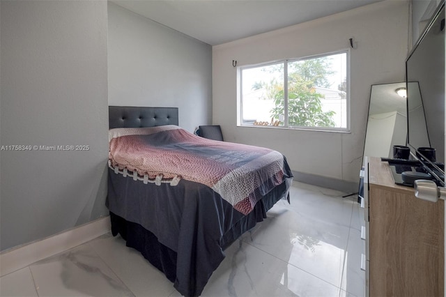 bedroom with marble finish floor and baseboards