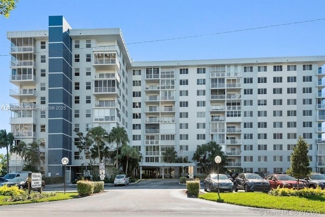 view of building exterior featuring uncovered parking