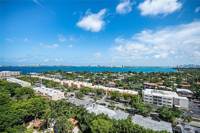 drone / aerial view featuring a view of city and a water view