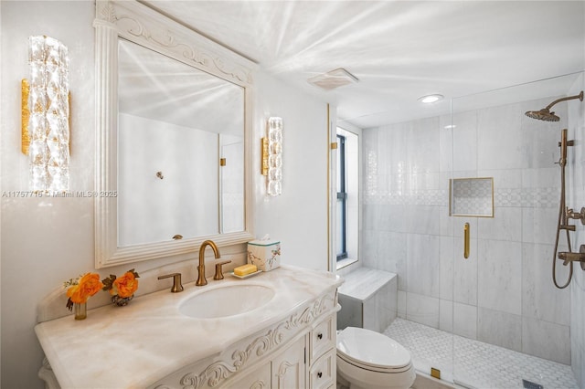 bathroom featuring toilet, a shower stall, visible vents, and vanity