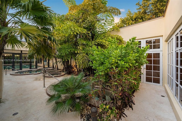 view of patio with an outdoor pool and french doors