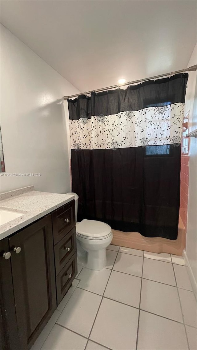 full bathroom with tile patterned flooring, toilet, vanity, and curtained shower