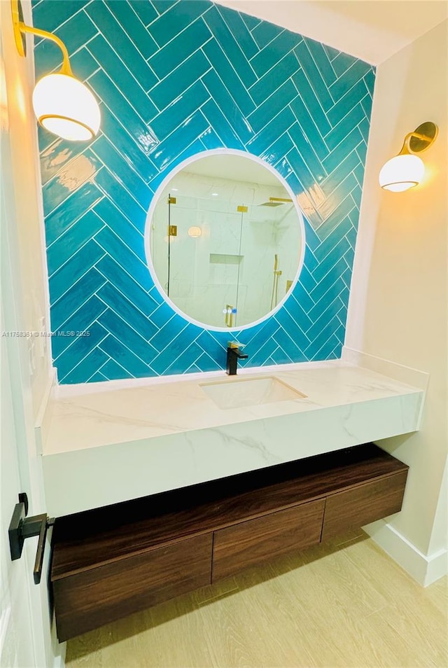 interior space featuring baseboards, walk in shower, and vanity