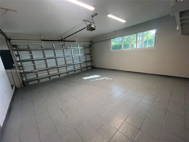 garage with baseboards and a garage door opener