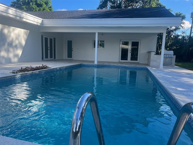 pool featuring exterior kitchen, french doors, a patio, and ceiling fan