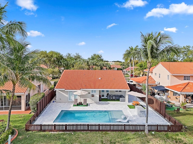 view of swimming pool featuring a fenced in pool, a fenced backyard, and a patio area