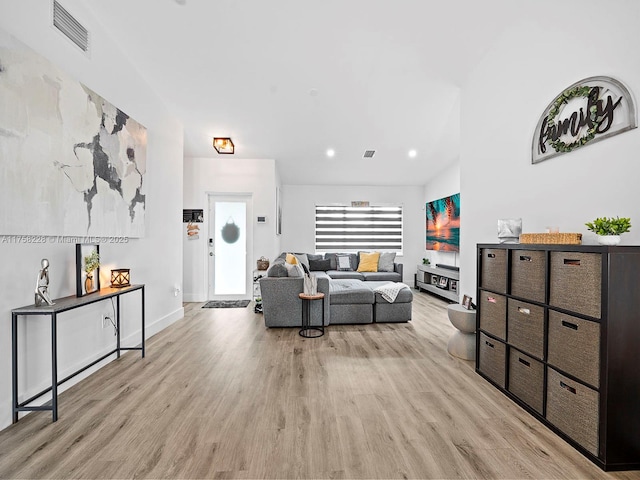 living area featuring recessed lighting, baseboards, visible vents, and light wood-type flooring