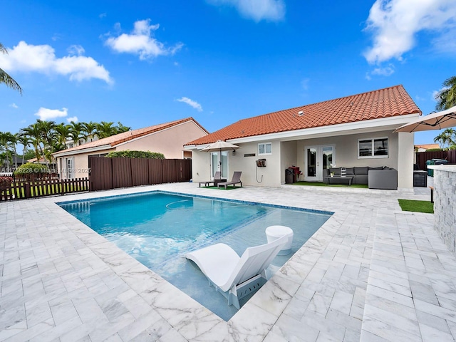 view of swimming pool featuring a fenced in pool, fence, french doors, outdoor lounge area, and a patio area