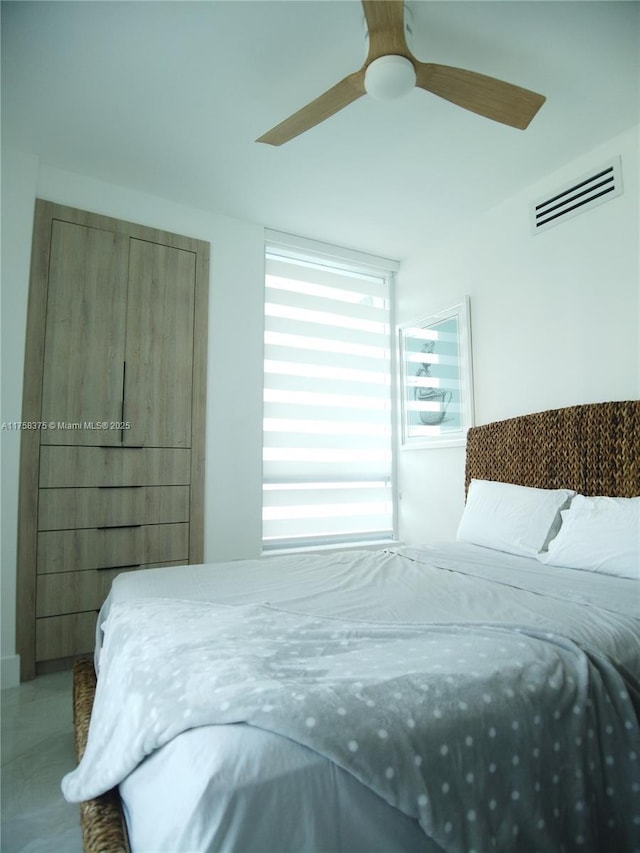 bedroom with visible vents and a ceiling fan