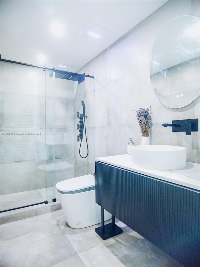 full bath featuring toilet, a shower stall, vanity, and tile walls