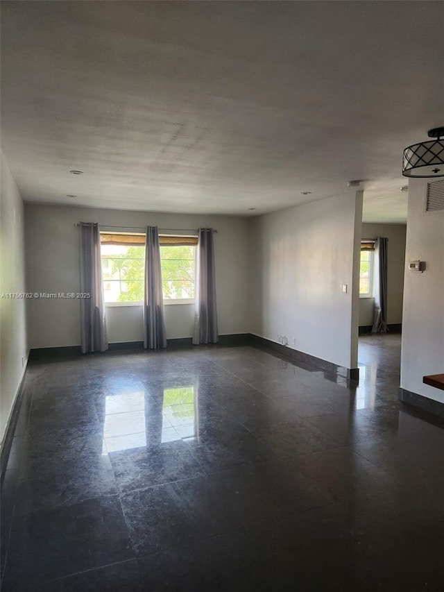 empty room featuring visible vents and baseboards