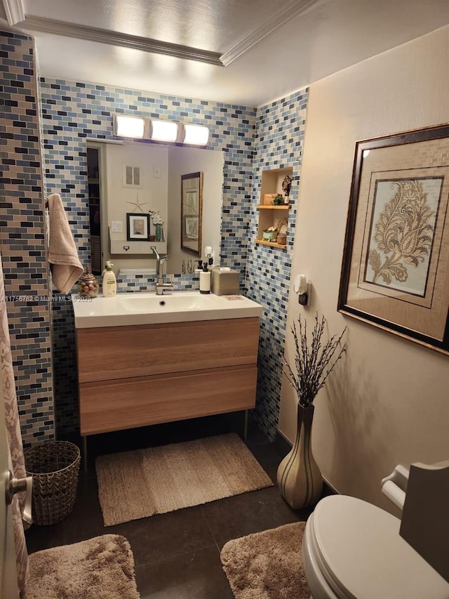 bathroom featuring tasteful backsplash, visible vents, toilet, tile patterned floors, and vanity