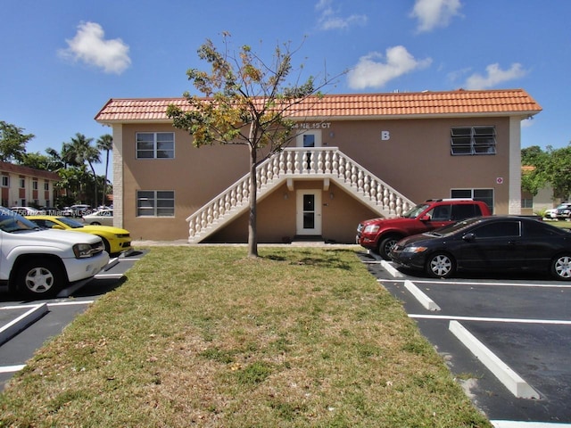 exterior space featuring stairs and uncovered parking