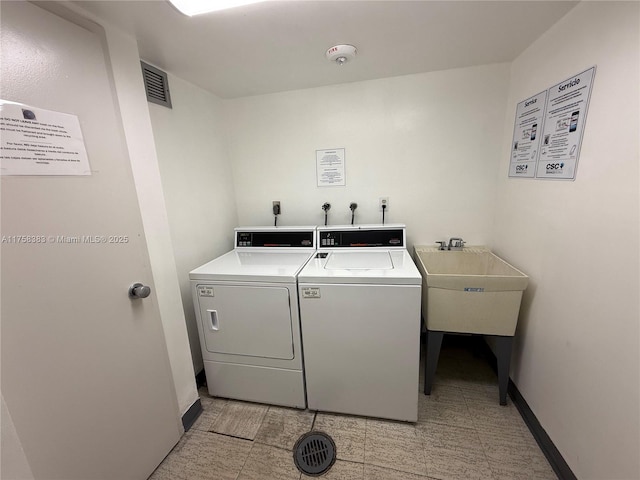 shared laundry area featuring visible vents, baseboards, and separate washer and dryer