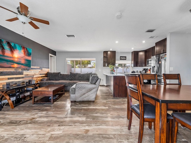 dining area with recessed lighting, visible vents, and light wood-style flooring