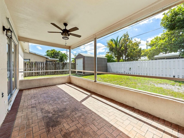 unfurnished sunroom with a wealth of natural light and ceiling fan