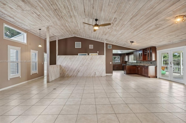 unfurnished living room featuring light tile patterned floors, visible vents, wood ceiling, french doors, and wood walls