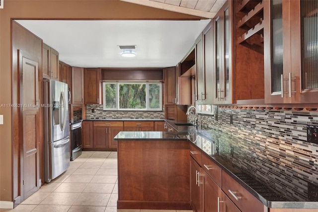 kitchen featuring light tile patterned floors, visible vents, stainless steel fridge with ice dispenser, a sink, and backsplash