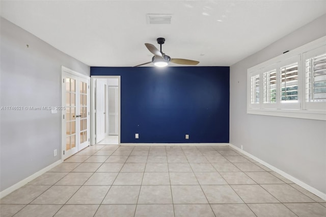 spare room with light tile patterned floors, baseboards, visible vents, ceiling fan, and french doors