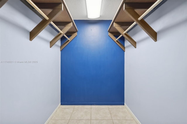 walk in closet featuring tile patterned flooring