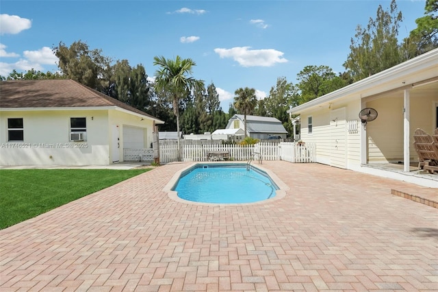 view of pool with a fenced in pool, a yard, a patio, fence, and cooling unit