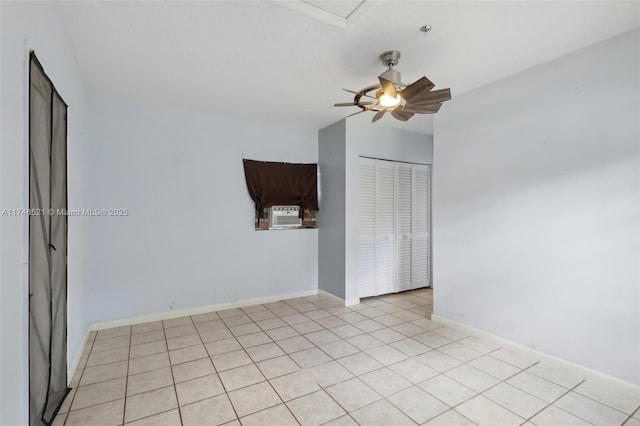 spare room featuring baseboards and a ceiling fan