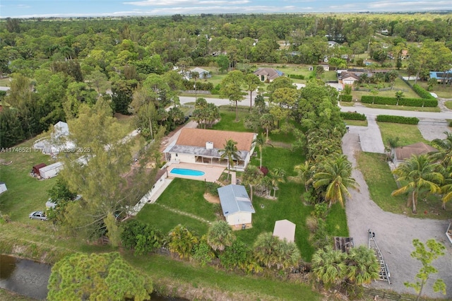 bird's eye view with a wooded view