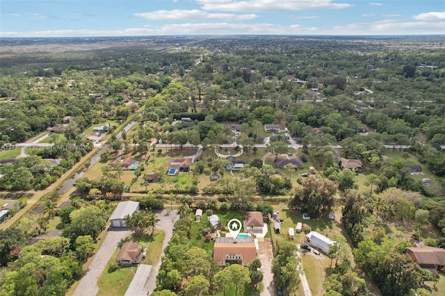 bird's eye view with a wooded view