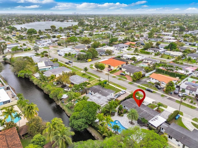 drone / aerial view featuring a water view and a residential view