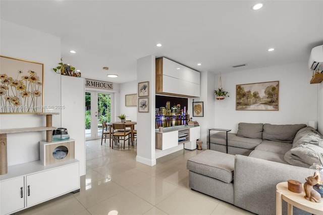 living area with french doors, light tile patterned floors, recessed lighting, visible vents, and baseboards